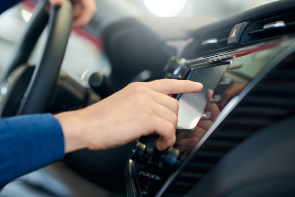 Male hand touching car sensor panel